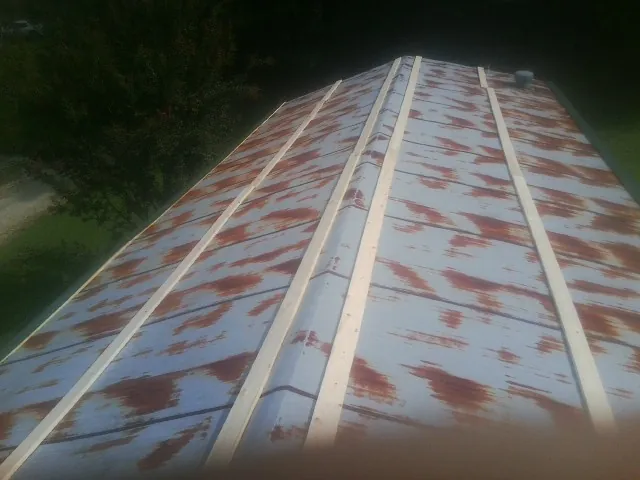 Rusted metal roof panels with new wood purlins before replacement — Storm Damage Roof Repair in Rainbow City by Roofing Brothers